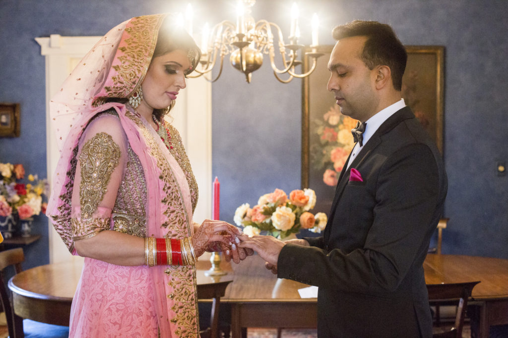 Vancouver wedding couple exchanging rings in Ann Moore's Kitsilano residence