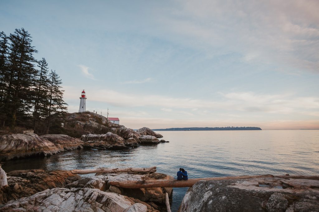 Lighthouse park engagement session during sunset overlooking the Vancouver horizon and lighthouse