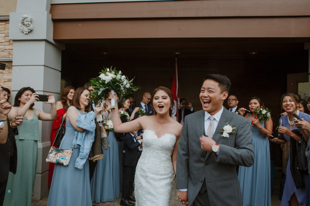 Bride and groom exiting the church after getting married in coquitlam