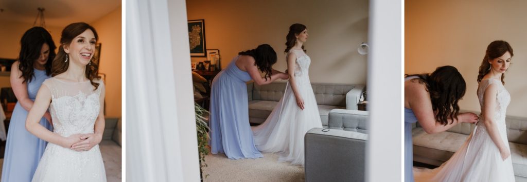 Maid of honour helping to button up the wedding gown on. the bride