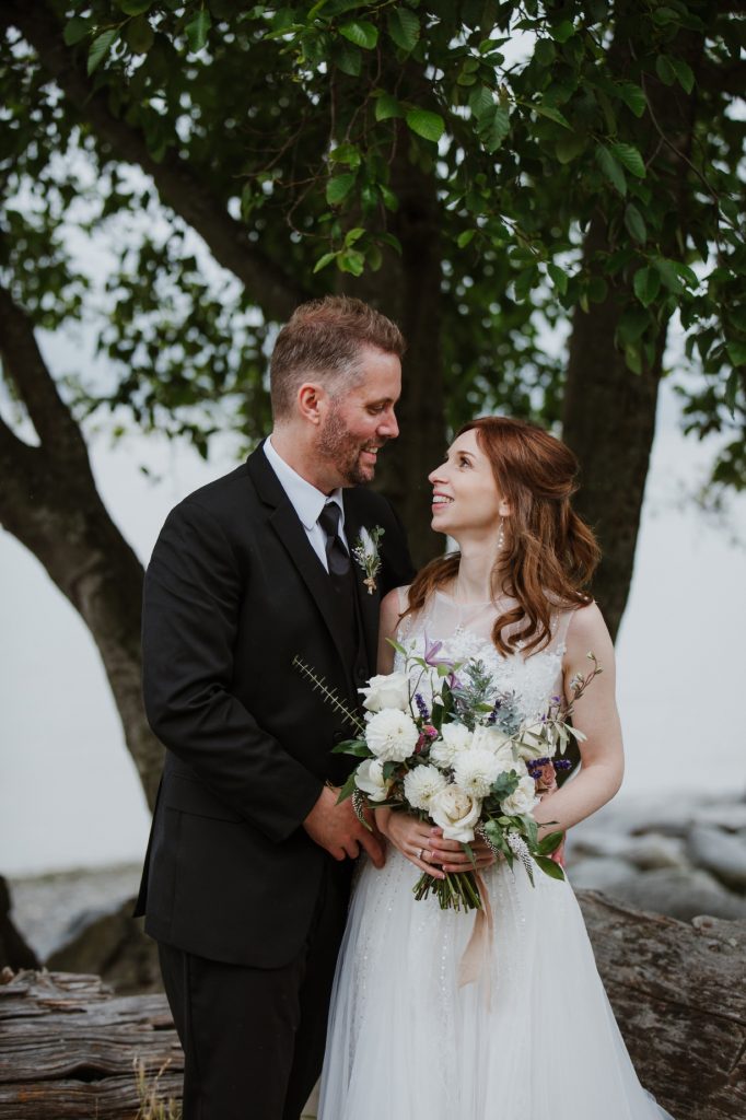 Bride and groom looking at each other during their portrait session in spanish banks