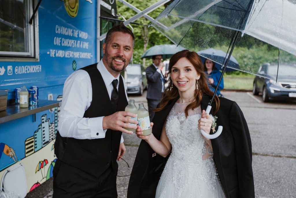 Portrait of bride and groom by the ckickpea food truck in spanish banks