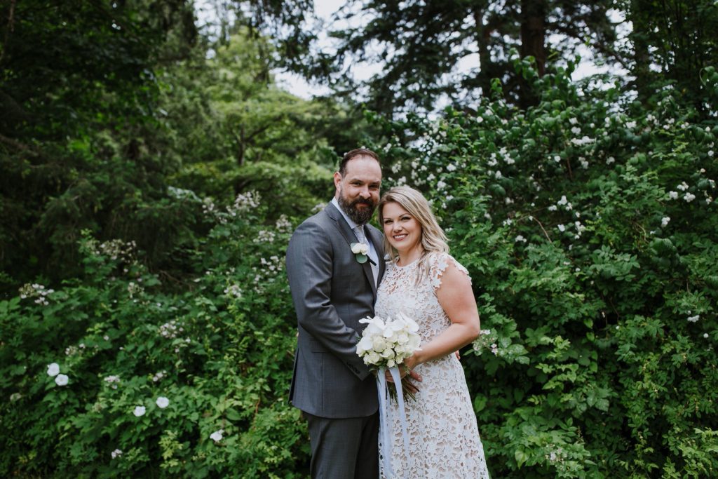 Formal photo of bride and groom looking at the camera