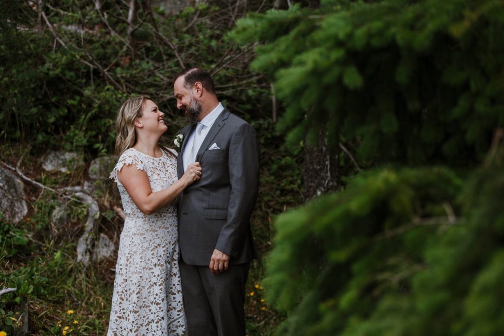 Bride and groom looking at each other in whytecliff park