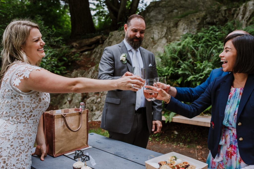 Bride and groom celebrating with a champagne toast with their witnesses after the elopement ceremony